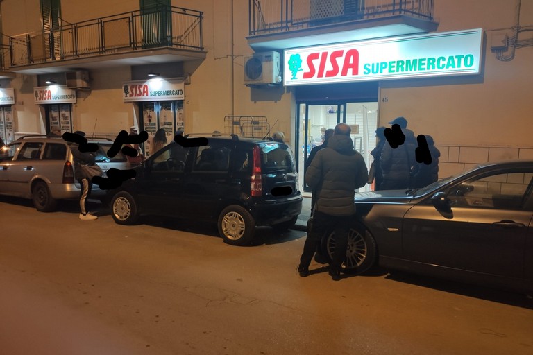 Molfettesi in fila fuori a un supermercato